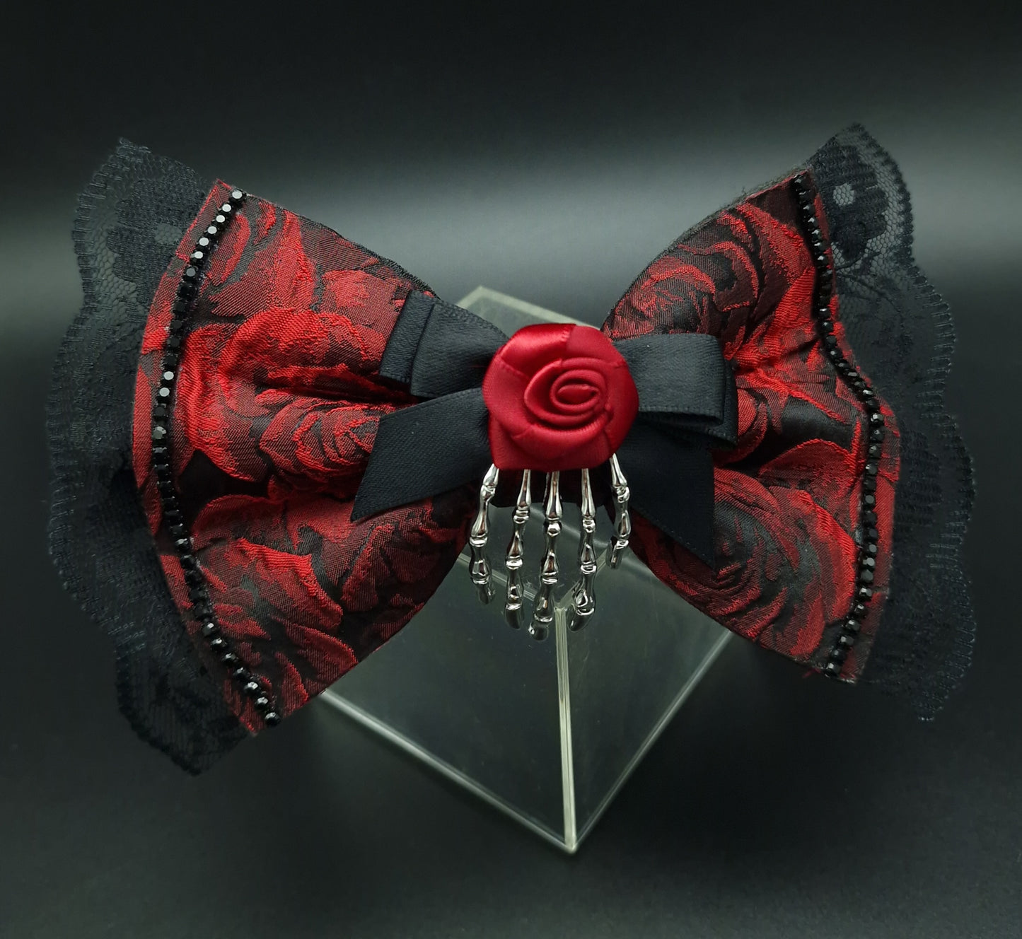 Red rose bow with removable skeleton hand broach