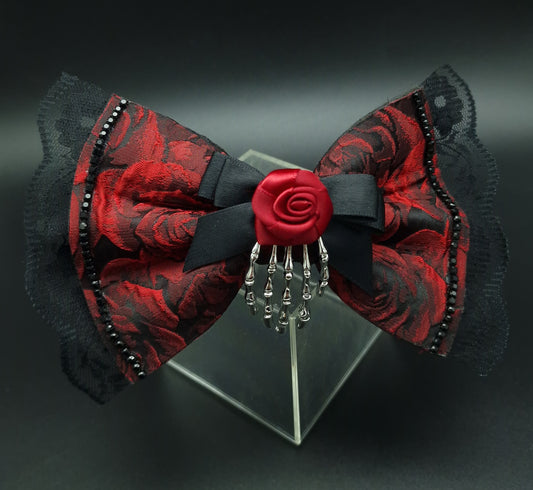 Red rose bow with removable skeleton hand broach